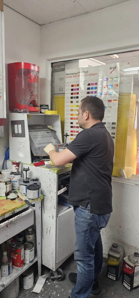 Hovee's technician performing paint work in the shop
